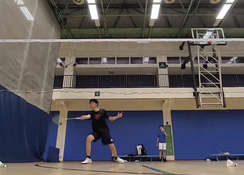 Playing badminton on an indoor court