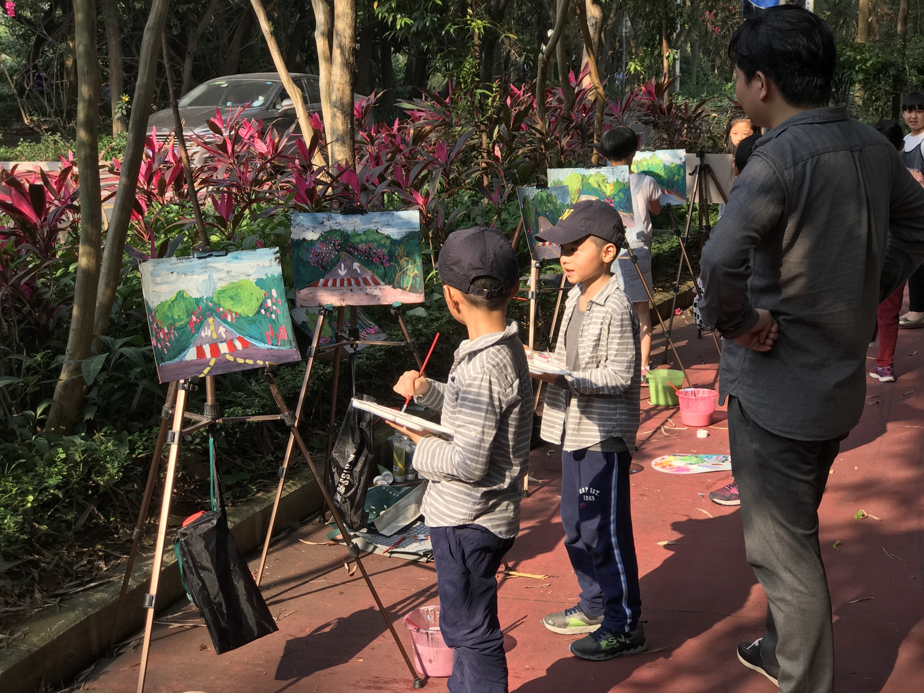 My brother and me painting outdoors at easels as children